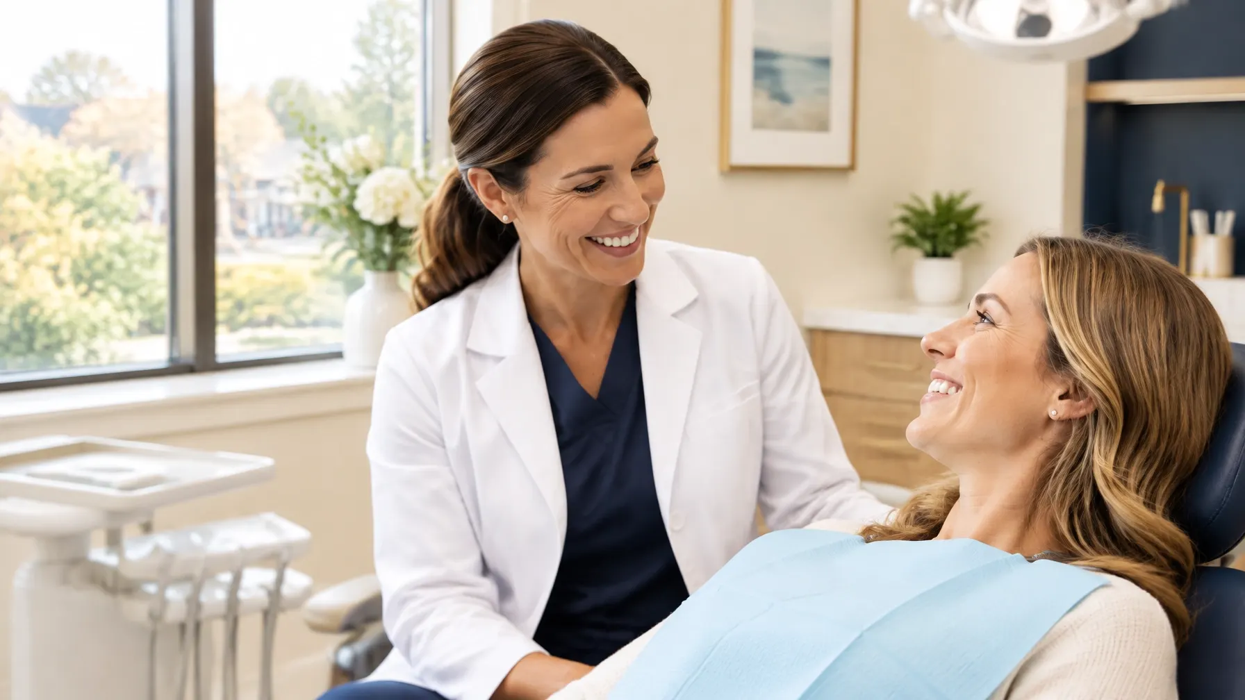 Dentist warmly speaking with a relaxed patient in a bright contemporary treatment room